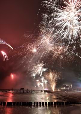 Fireworks over a pier at night