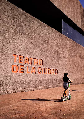 Teatro De La Ciudad Sign with Person on Scooter