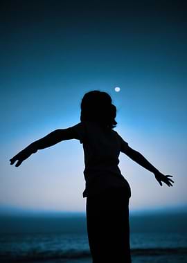Silhouette of a person with arms outstretched