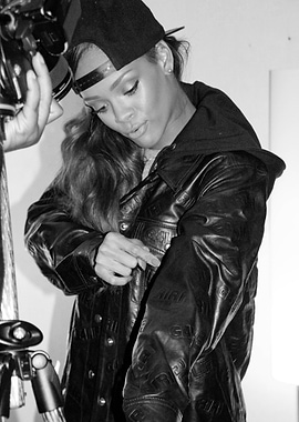 Rihanna in a leather jacket and baseball cap