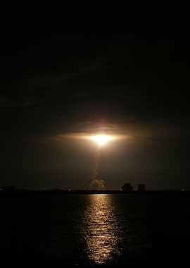 Rocket Launch Over Water at Night