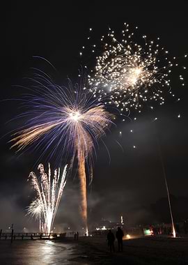 Fireworks over a beach at night