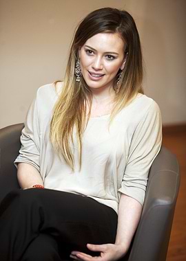 Hilary Duff Sitting in a Chair