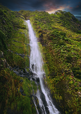 Majestic Waterfall Cascading Down a Lush Green Mountain