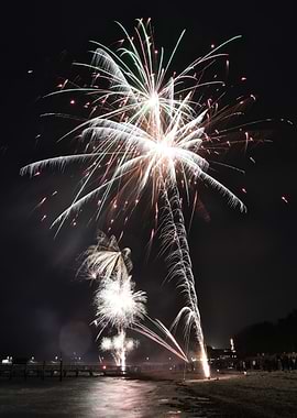 Fireworks over a beach at night