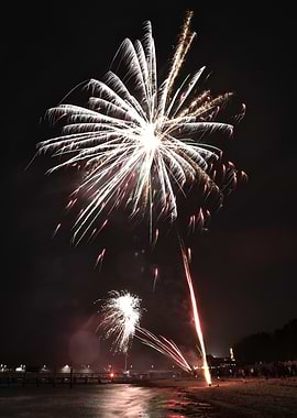 Fireworks over a beach at night