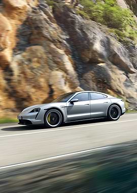 Silver Porsche Taycan Driving on Scenic Road