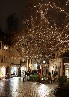Street decorated with Christmas lights at night