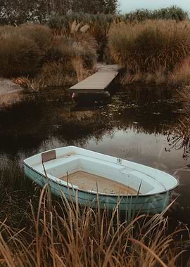 Rowboat on a calm pond with a wooden walkway