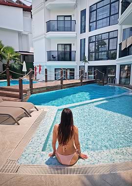 Woman in bikini by the pool