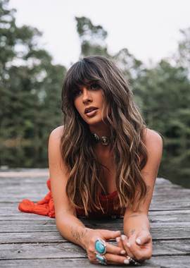 ella langley in red dress on wooden dock