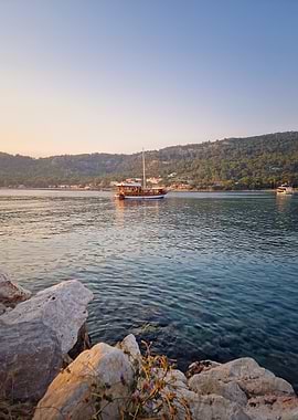 Boat on calm sea at sunset