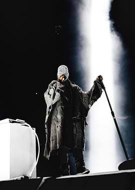 Performer in a mask on stage Kanye West