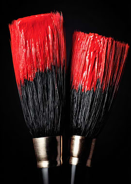 Two Paint Brushes with Red Paint