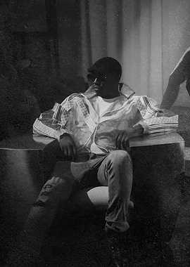 Man in a patterned jacket sitting