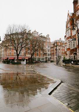 Wet London Street with Red Brick Buildings