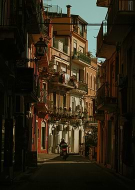 Motorcyclist in Narrow traditional Italian street