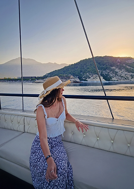 Woman on a boat at sunset