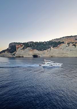 Yacht sailing near a coastal cave