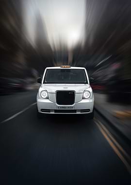 White Edinburgh Taxi in Motion