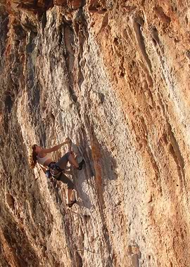 Woman rock climbing on a cliff