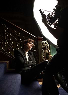 Man on stairs with camera crew