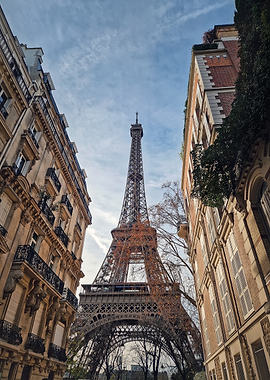Eiffel Tower between Parisian Buildings