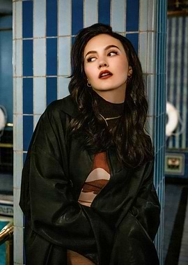 iris apatow in dark coat and patterned top