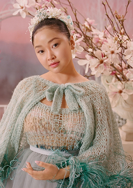 Lana Condor in a floral and feathered outfit