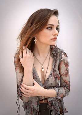 joey king in patterned blouse with jewelry