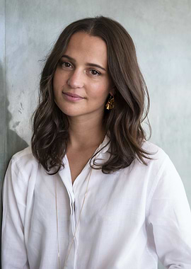 alicia vikander in white shirt with gold earrings