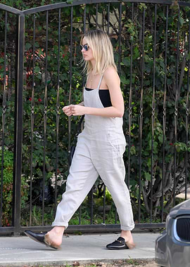 Woman in Overalls Walking Outdoors