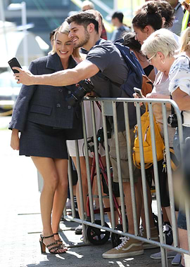 Margot Robbie takes a selfie with a fan