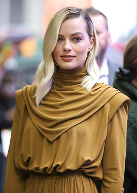 Margot Robbie in a stylish brown dress