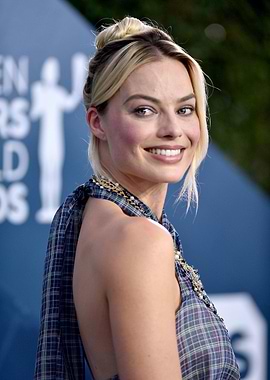 Margot Robbie smiling at an event