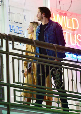 Couple looking at neon signs