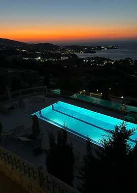Poolside at Dusk with Coastal Town View