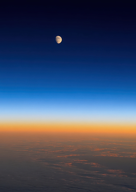 Moon over clouds at sunset