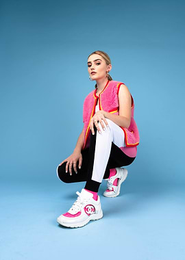 Meg Donnelly in pink vest and athletic wear