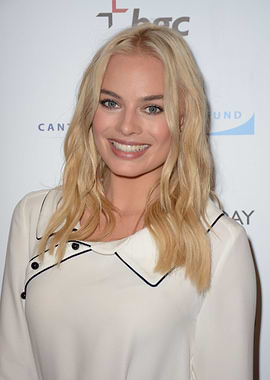Margot Robbie smiling at event