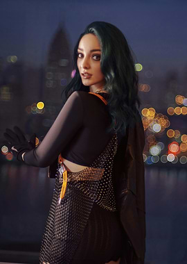 Emma Dumont with green hair in black outfit