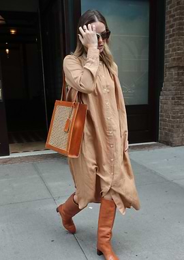 Woman in tan dress and boots