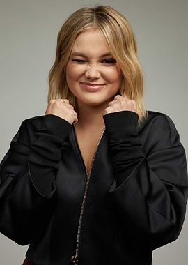 Olivia Holt winking and making fists
