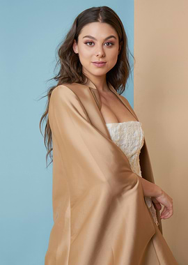 Kira Kosarin in a gold shawl and white corset