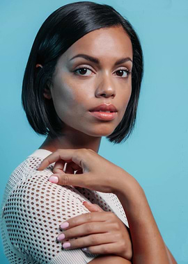 Georgina Campbell with short dark hair and mesh top