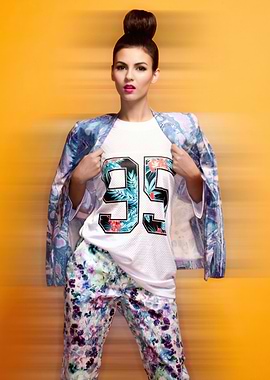 Victoria Justice in floral print outfit with '95' shirt