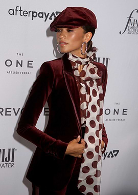 Zendaya in a velvet suit and cap