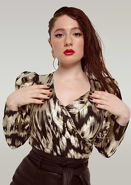 Emma Kenney in metallic gold and black top