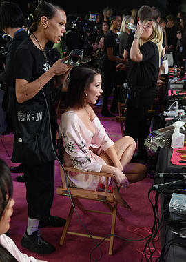 Model getting hair styled backstage