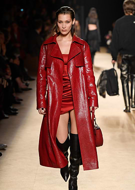 Bella Hadid in a red patent trench coat